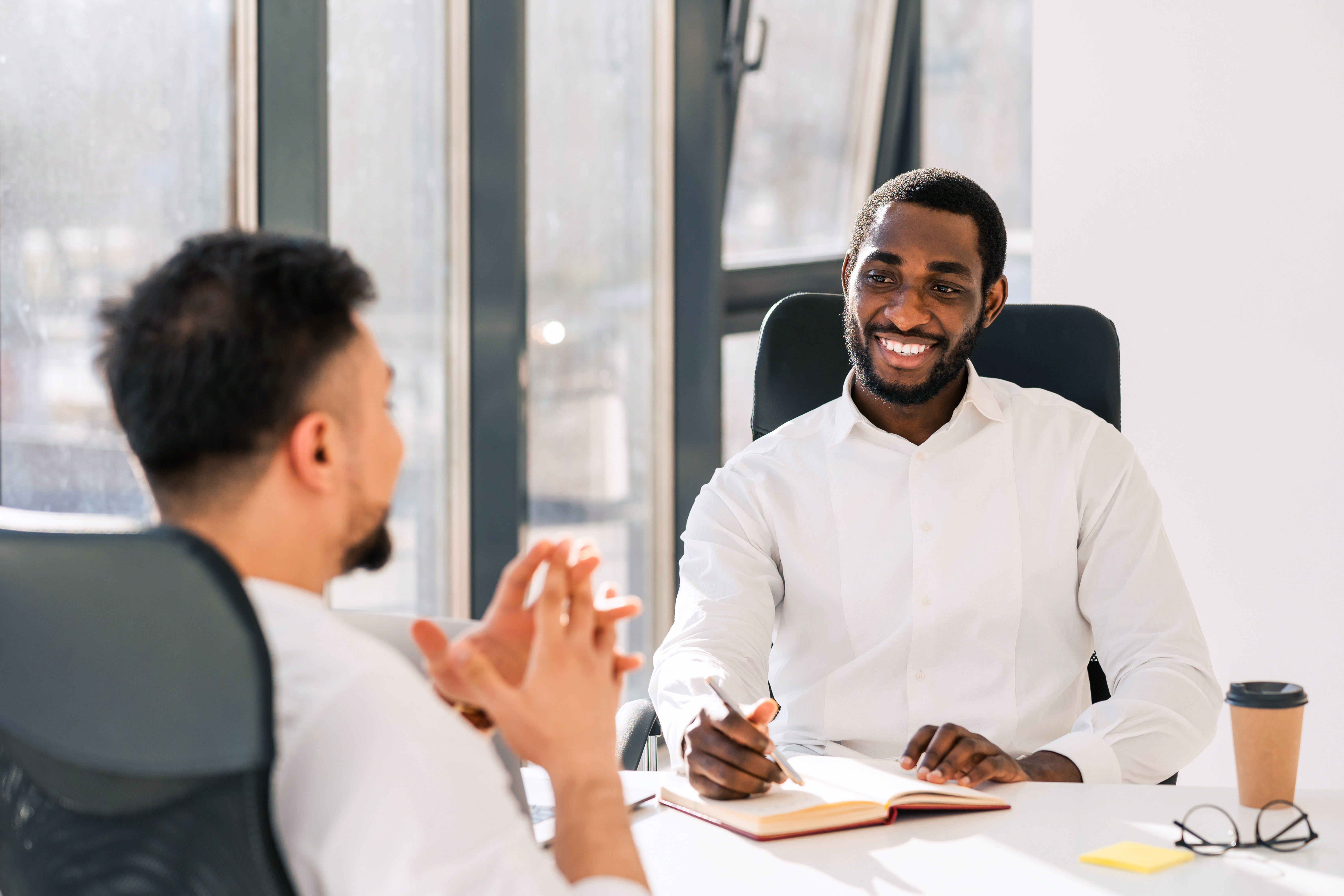 Man presenting to a table or colleagues 