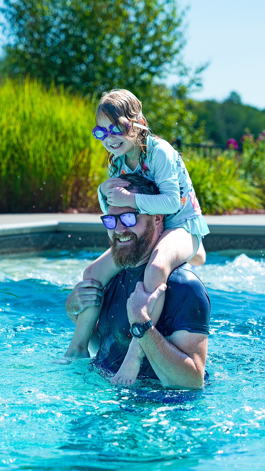 Second image: A bearded man with a small girl on his shoulders in a pool. Title: Vote. Text: Oct. 23 – 30, 2025. 