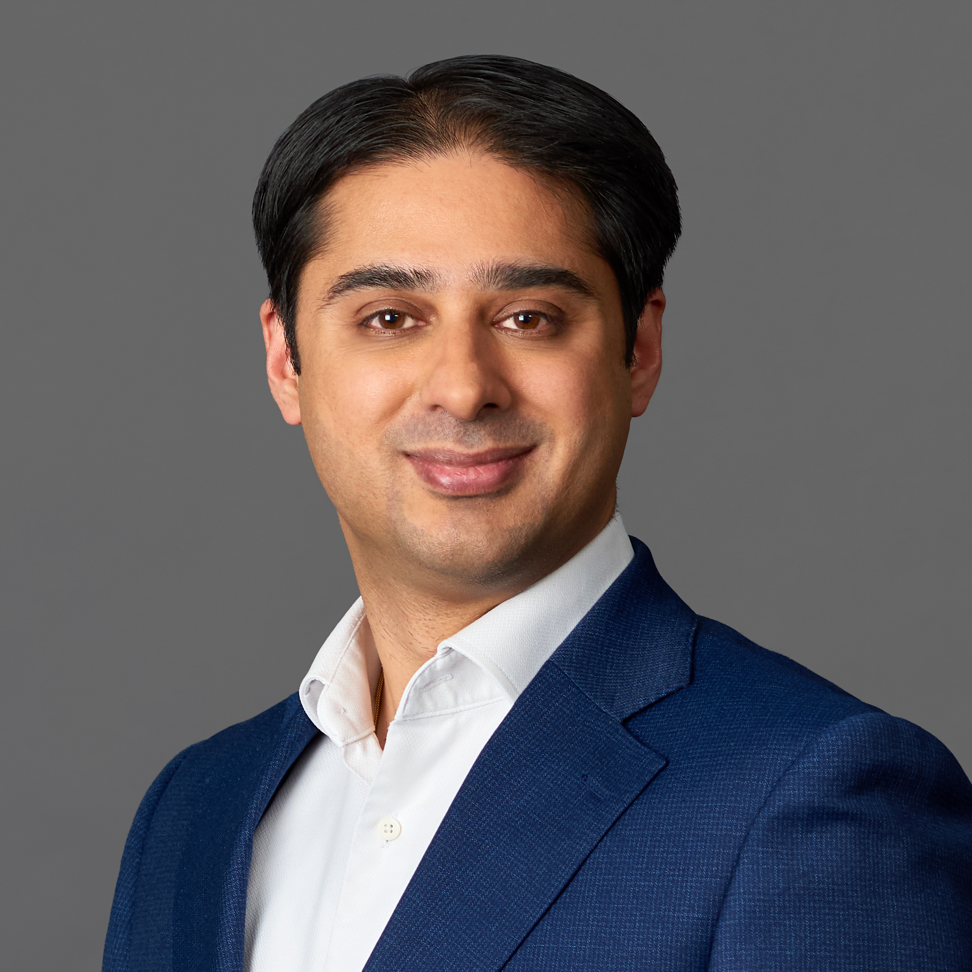 Close up headshot portrait of smiling young Caucasian businessman in glasses posing in office. Profile picture of happy millennial male employee or worker in eyewear at workplace. Employment concept.