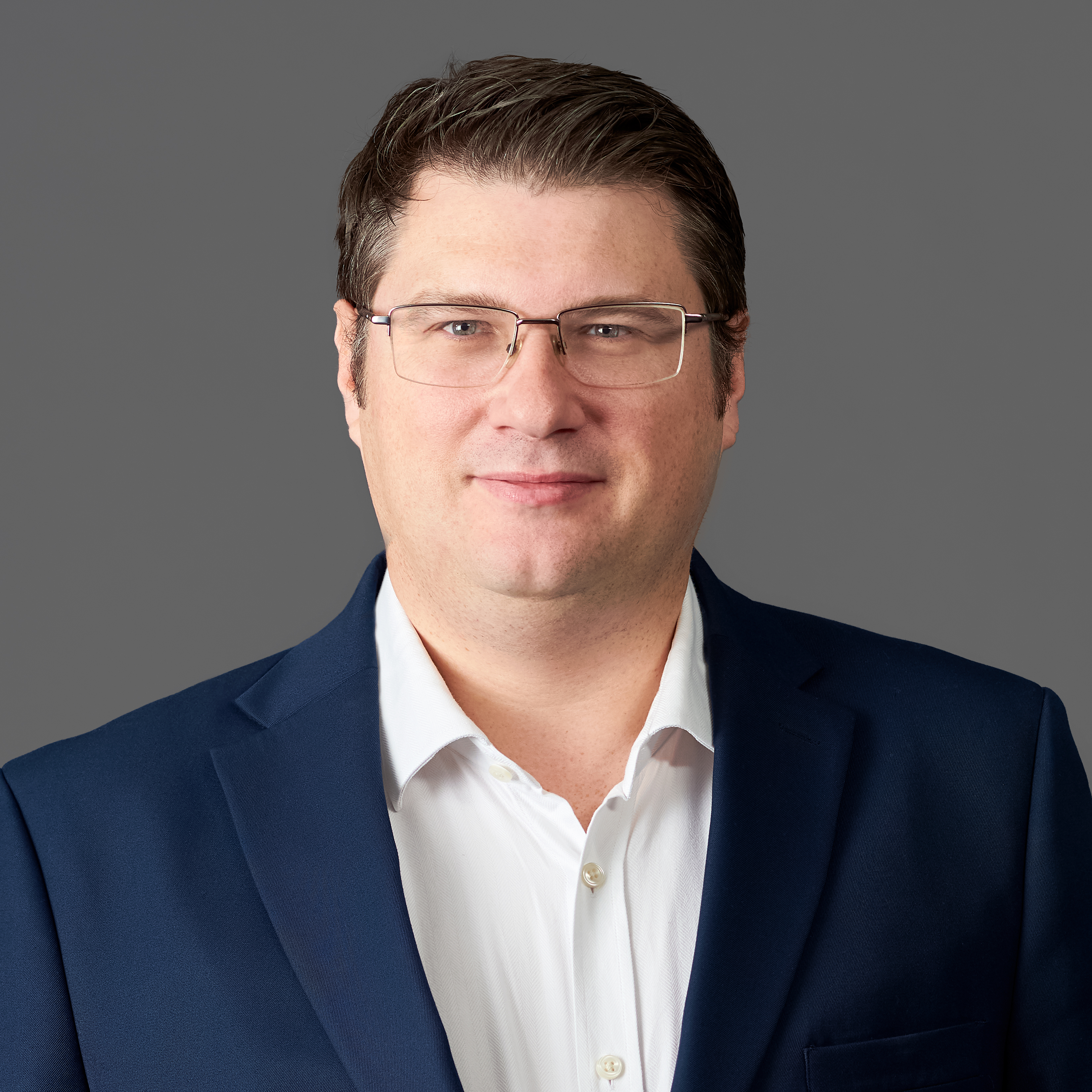 Headshot portrait of smiling young African American businessman in suit pose in own modern office. Profile picture of happy successful male boss or CEO in formalwear show confidence and leadership.
