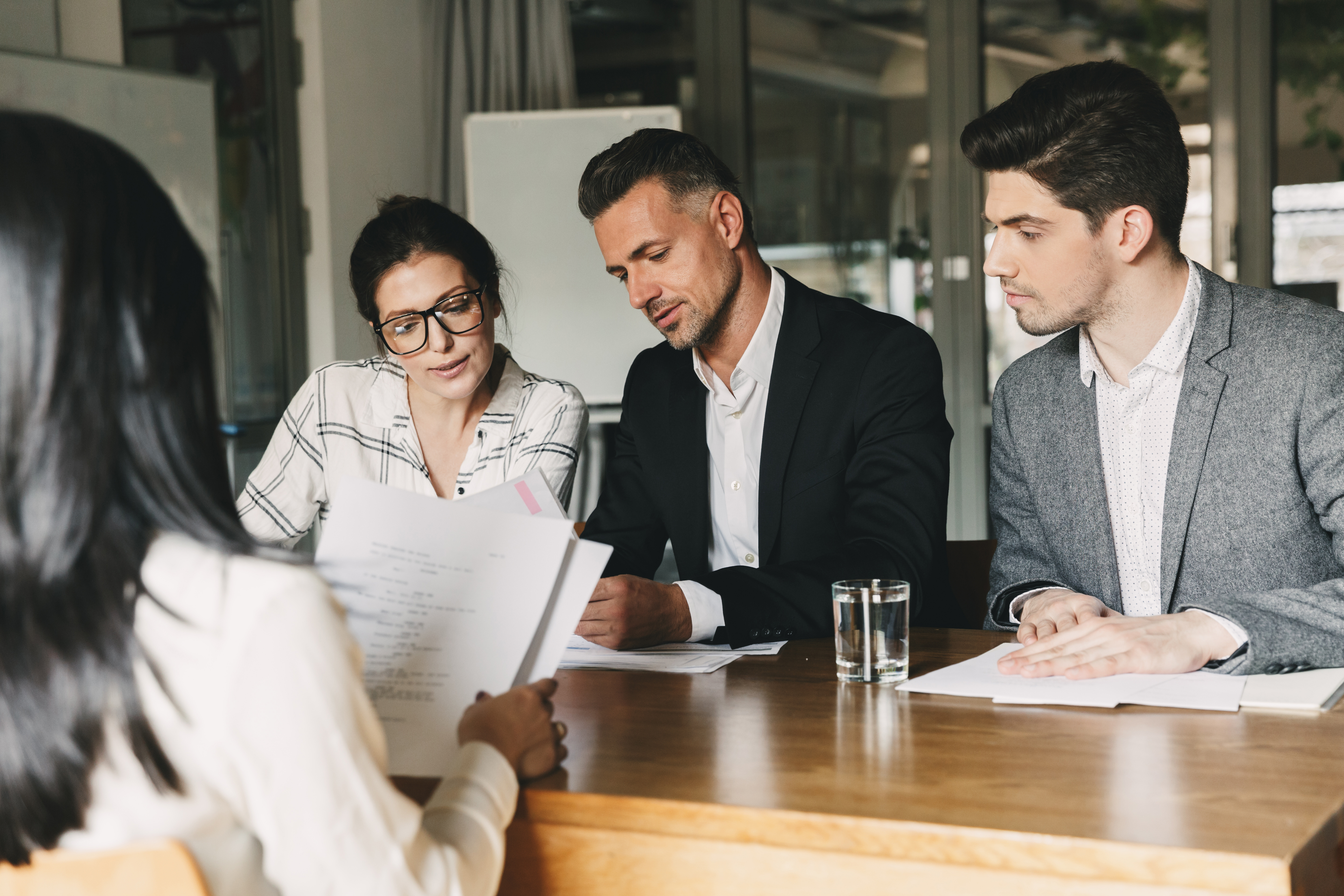 Group Of Businesswomen Collaborating In Creative Meeting Around Table In Modern Office