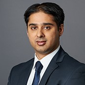 Headshot portrait of smiling young African American businessman in suit pose in own modern office. Profile picture of happy successful male boss or CEO in formalwear show confidence and leadership.