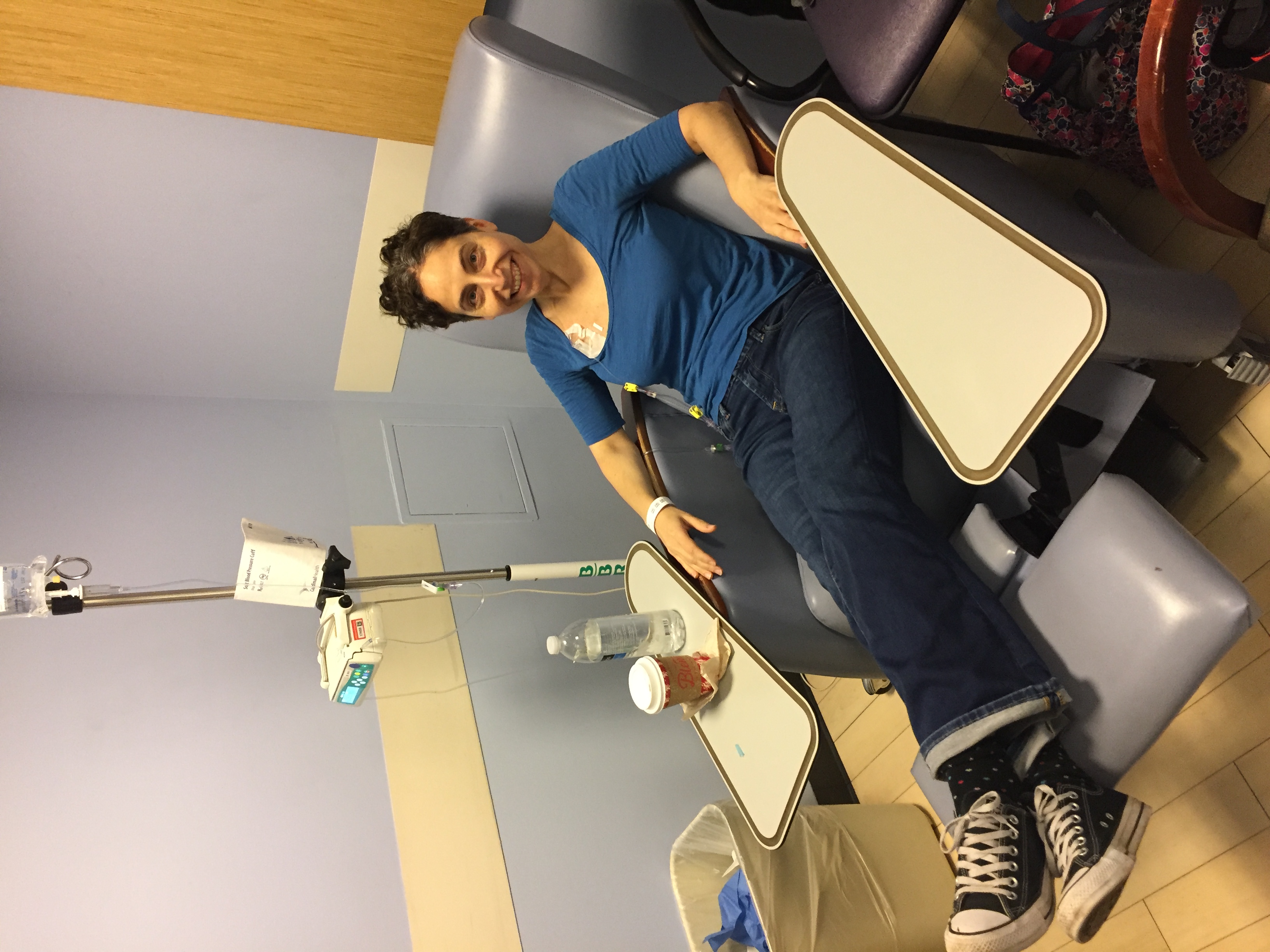Female in blue jumper receiving chemotherapy treatment. 