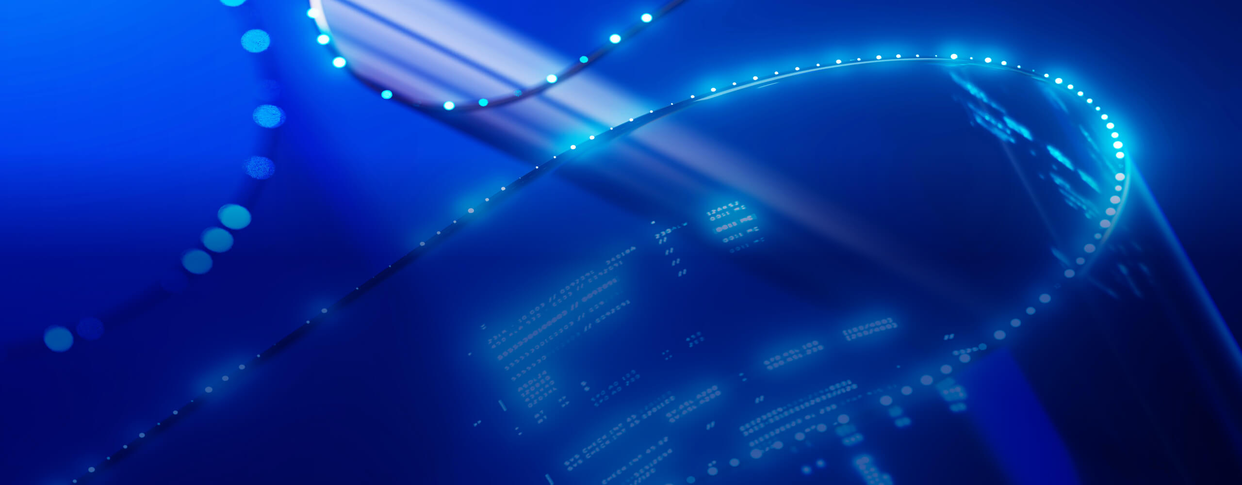 An abstract, futuristic blue background with curved, glowing lines and dotted patterns. There are light effects and digital elements, suggesting a theme related to technology, data, or digital communication.