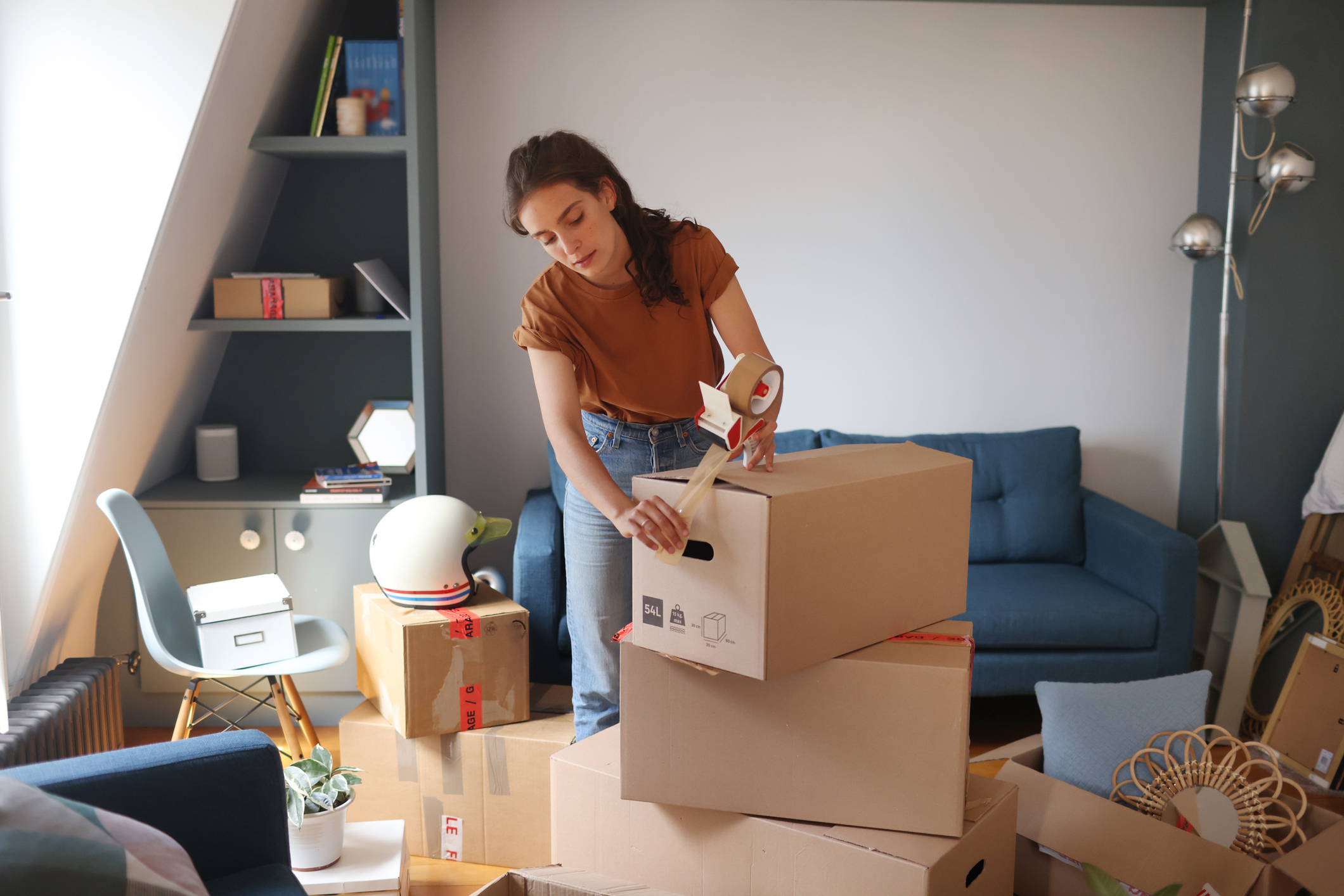 young adult woman packing for a move