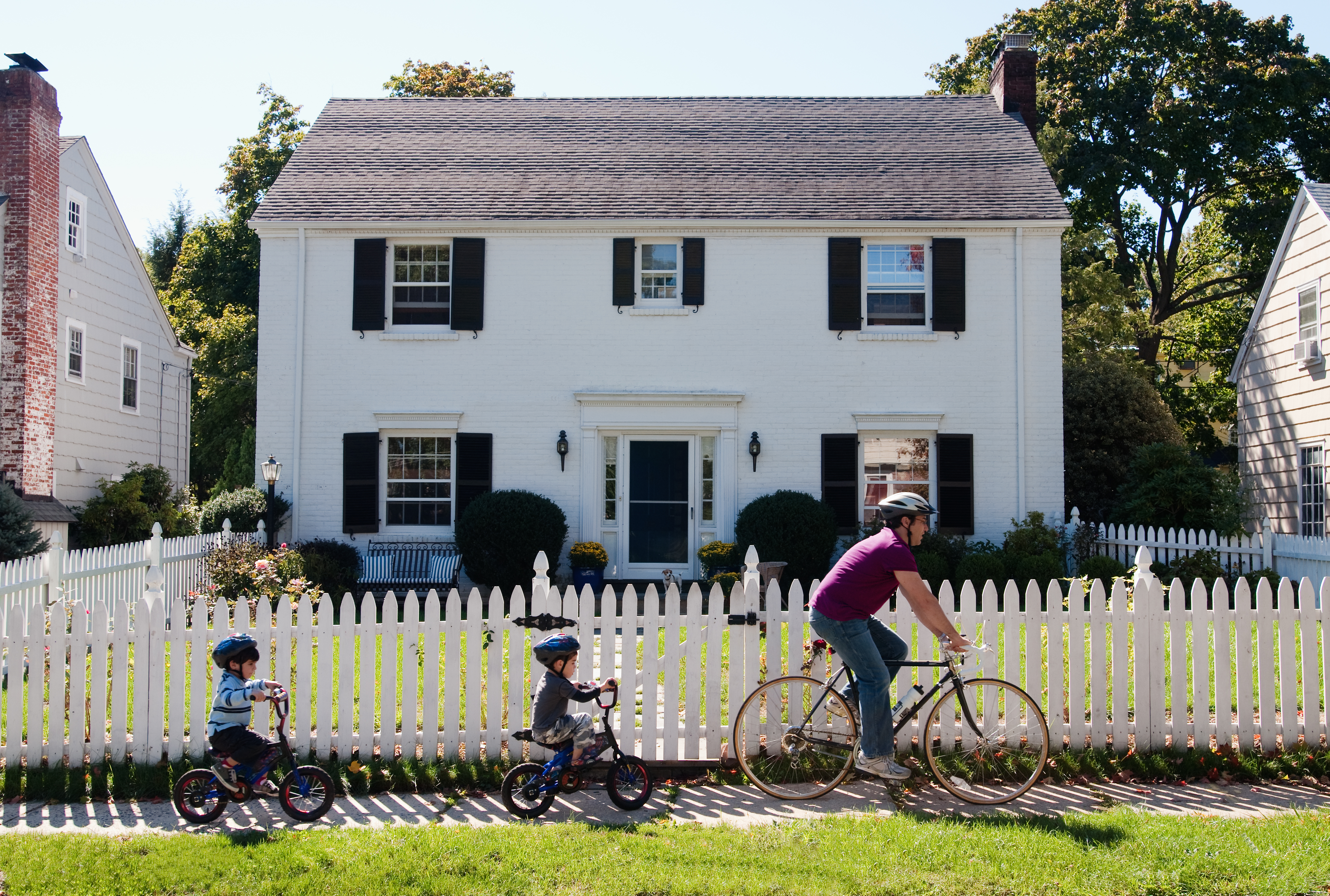family riding bikes in their neighborhood