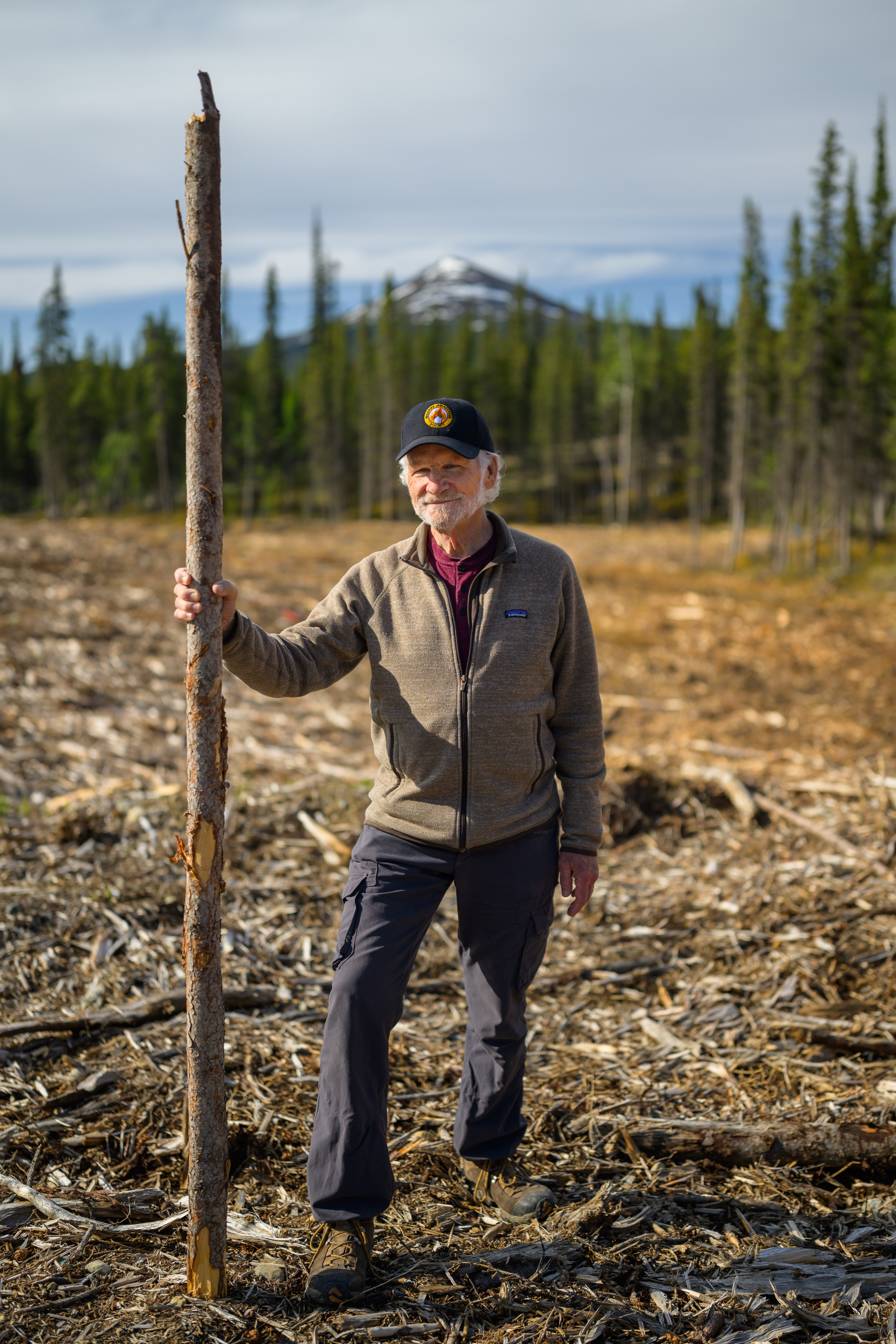 Portrait of Stuart Clark holding a tree branch in Whitehorse nature