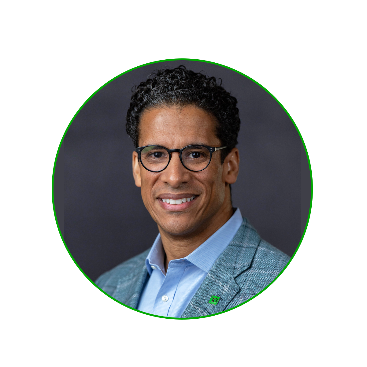 Headshot of Ted Paris: Black man with short, curly dark hair, wearing glasses in a blue suit