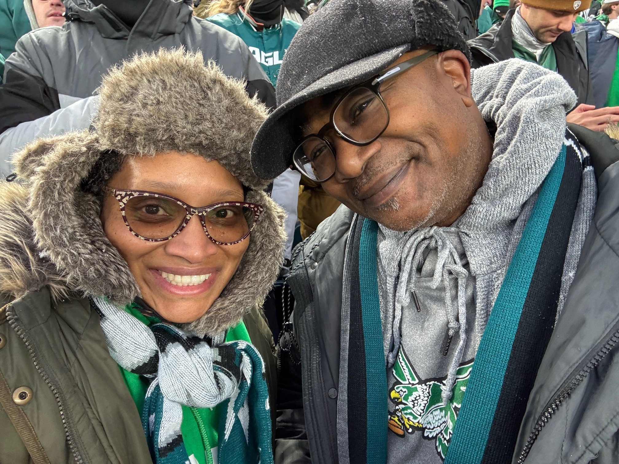 Two people, woman on the left and man on the right, at a Philadelphia Eagles game