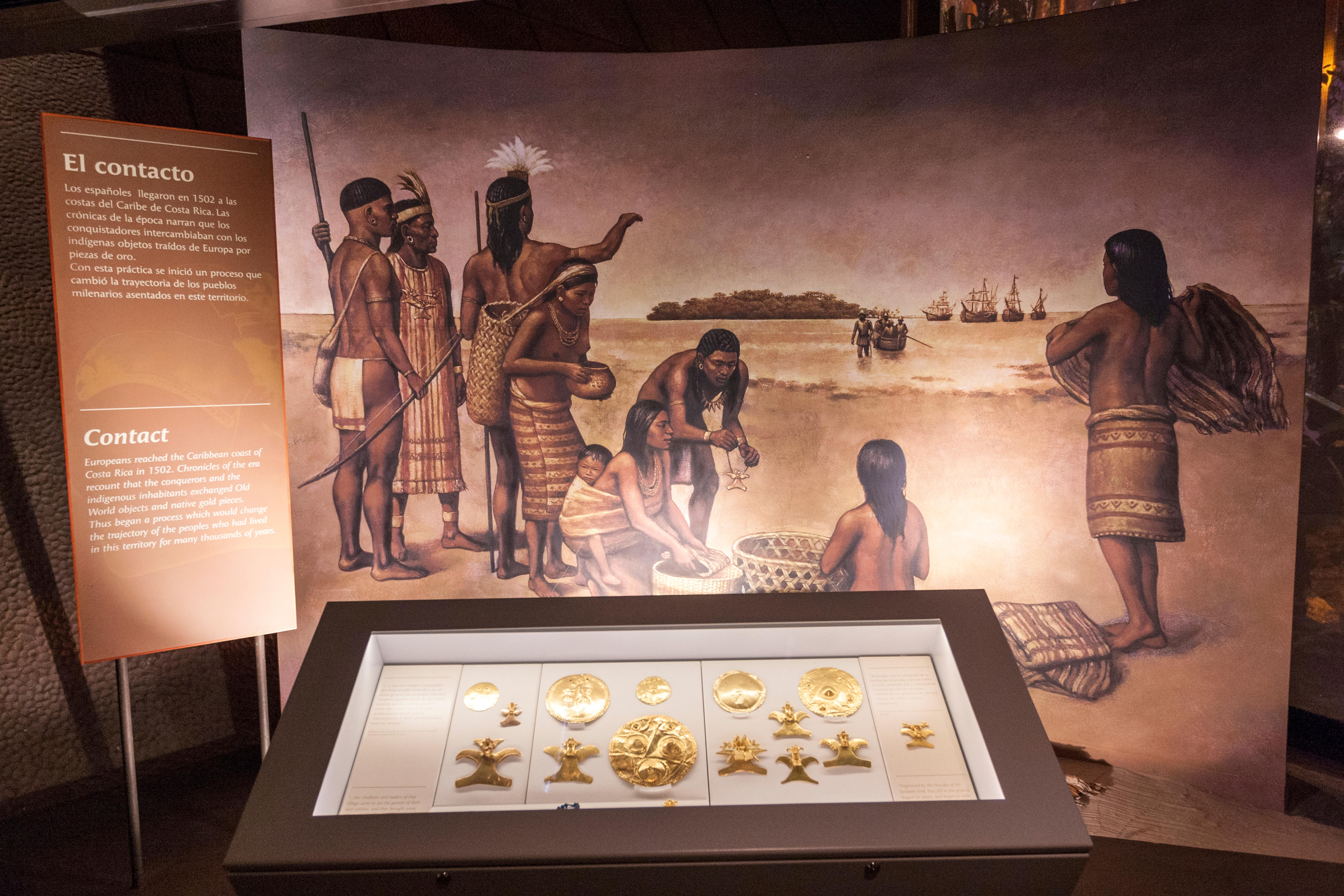Portrait of young cheerful woman standing in the office and laughing at the meeting with the colleagues