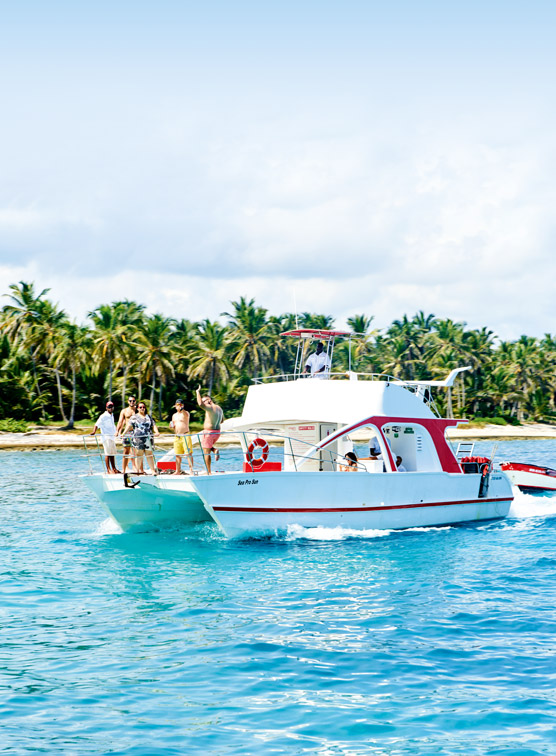 People standing on a boat close to shore.