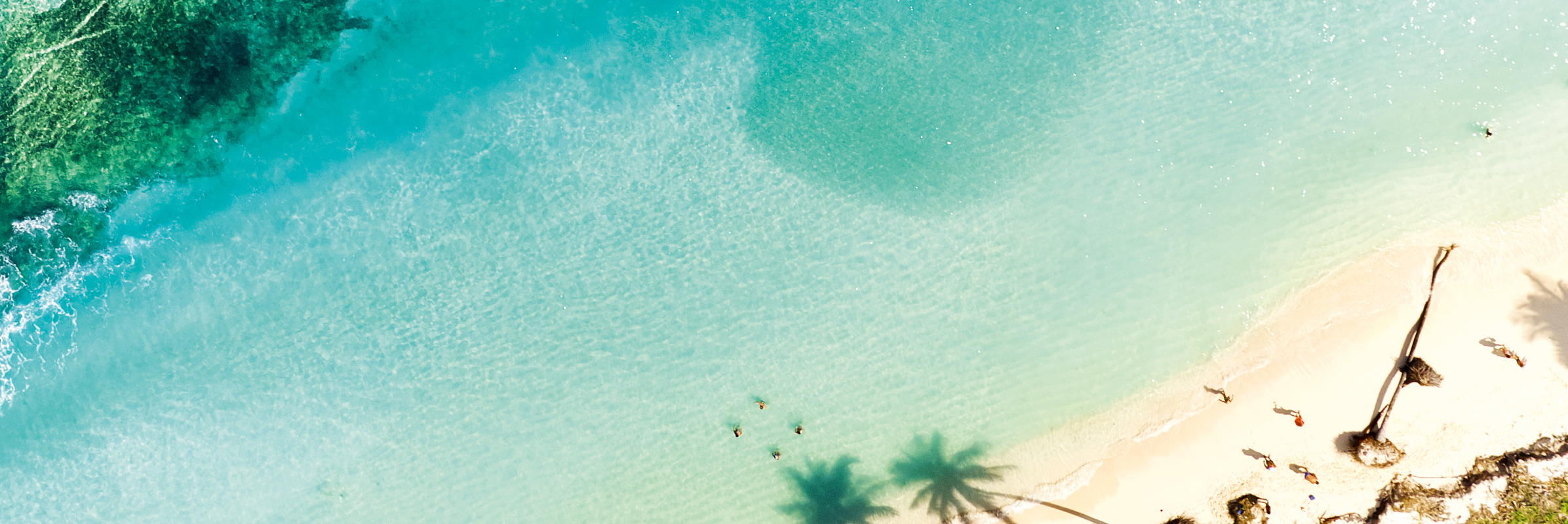 Beach with turquoise sea from above.