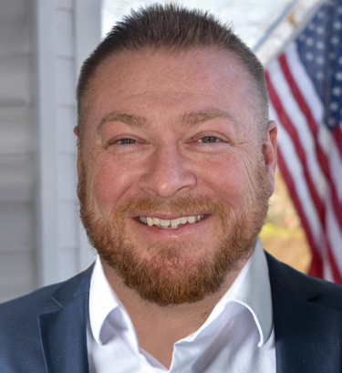 Headshot portrait of smiling young African American businessman in suit pose in own modern office. Profile picture of happy successful male boss or CEO in formalwear show confidence and leadership.