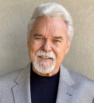 Headshot portrait of smiling young African American businessman in suit pose in own modern office. Profile picture of happy successful male boss or CEO in formalwear show confidence and leadership.
