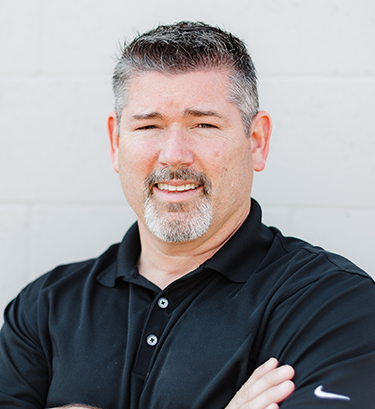 Close up headshot portrait of smiling young Caucasian businessman in glasses posing in office. Profile picture of happy millennial male employee or worker in eyewear at workplace. Employment concept.