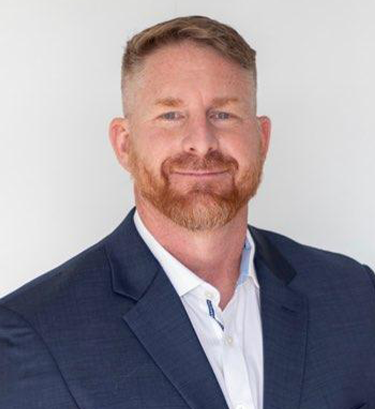Close up headshot portrait of smiling young Caucasian businessman in glasses posing in office. Profile picture of happy millennial male employee or worker in eyewear at workplace. Employment concept.