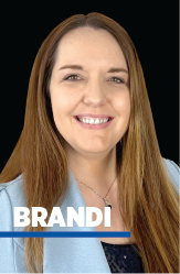 Attractive aged businesswoman, teacher or mentor coach speaking to young people, senior woman in glasses teaching audience at training seminar, female business leader speaker talking at meeting