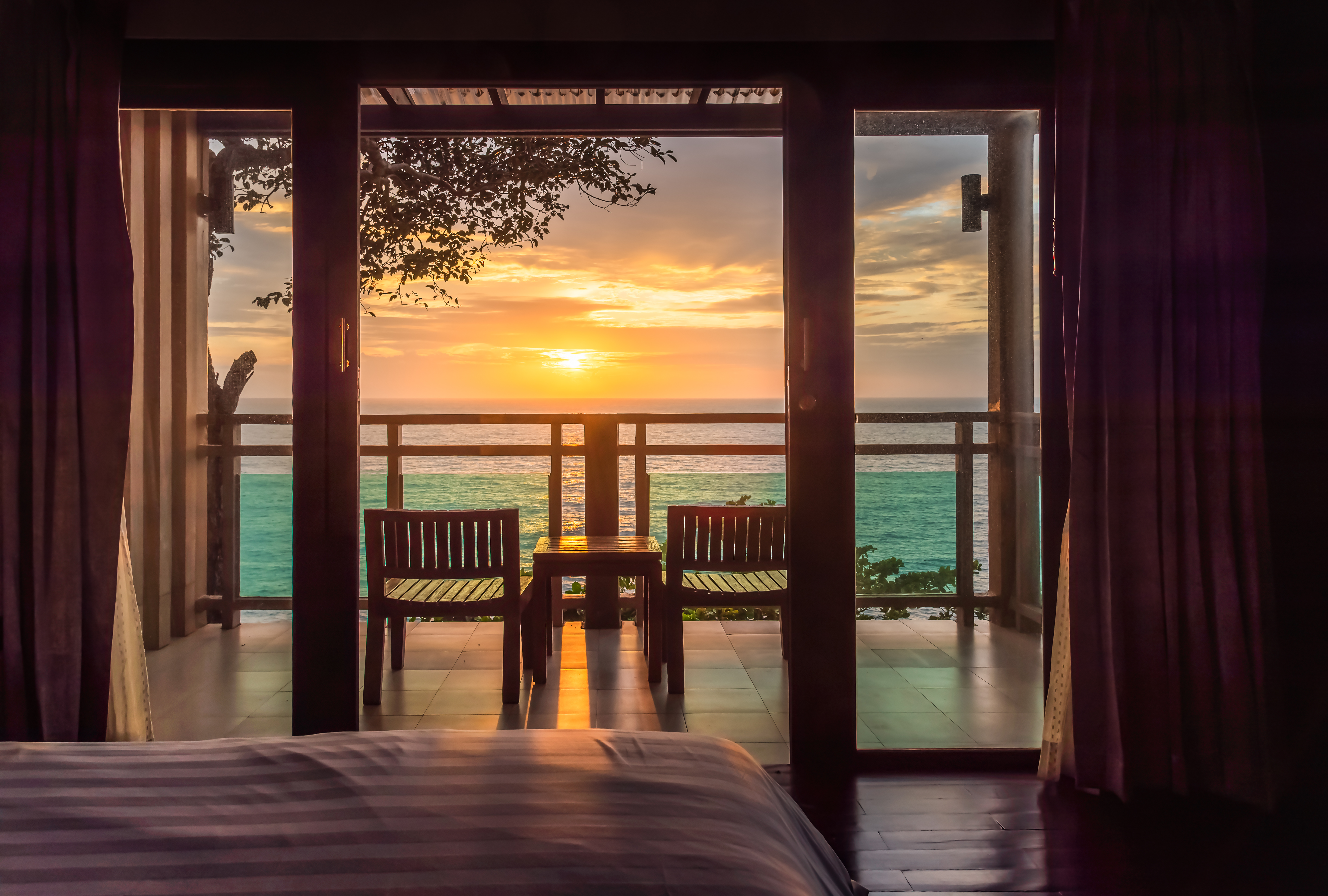 Ocean sunset view from bedroom balcony for travel concept.