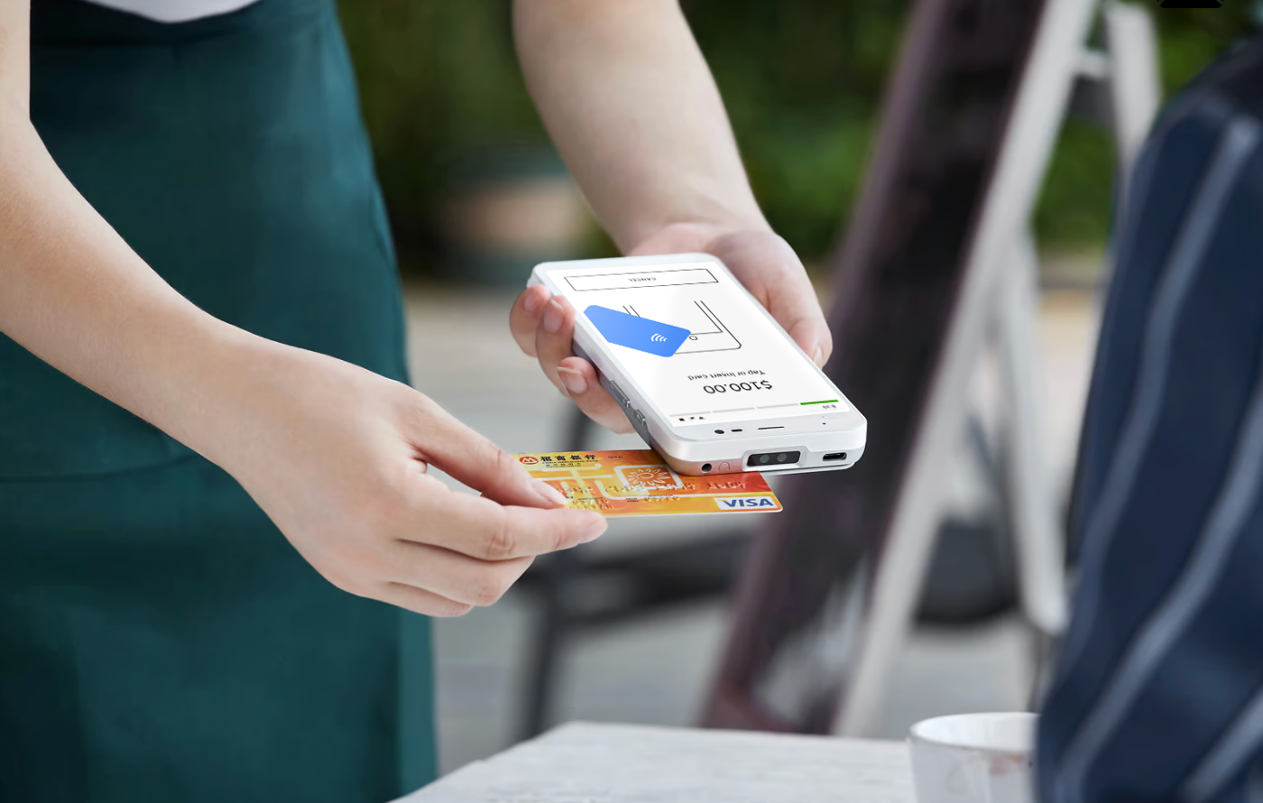 waitress using one hand to hold terminal and the other hand to swipe credit card through the terminal