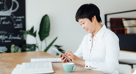 three young people laugh while looking at the same phone