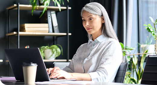 Happy young woman paying bill with a contactless credit card in a restaurant. Female smiling holding a creditcard and giving a payment transaction to the cashier. High quality photo