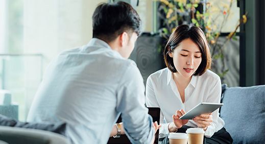 Two young shop owners using a laptop while working in a ceramic store. Female entrepreneurs managing online orders on their website. Young businesswomen running a creative small business together.