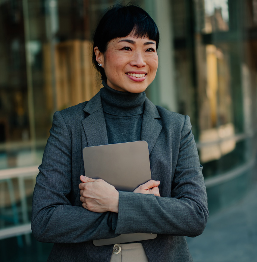 woman smiling while looking past laptop
