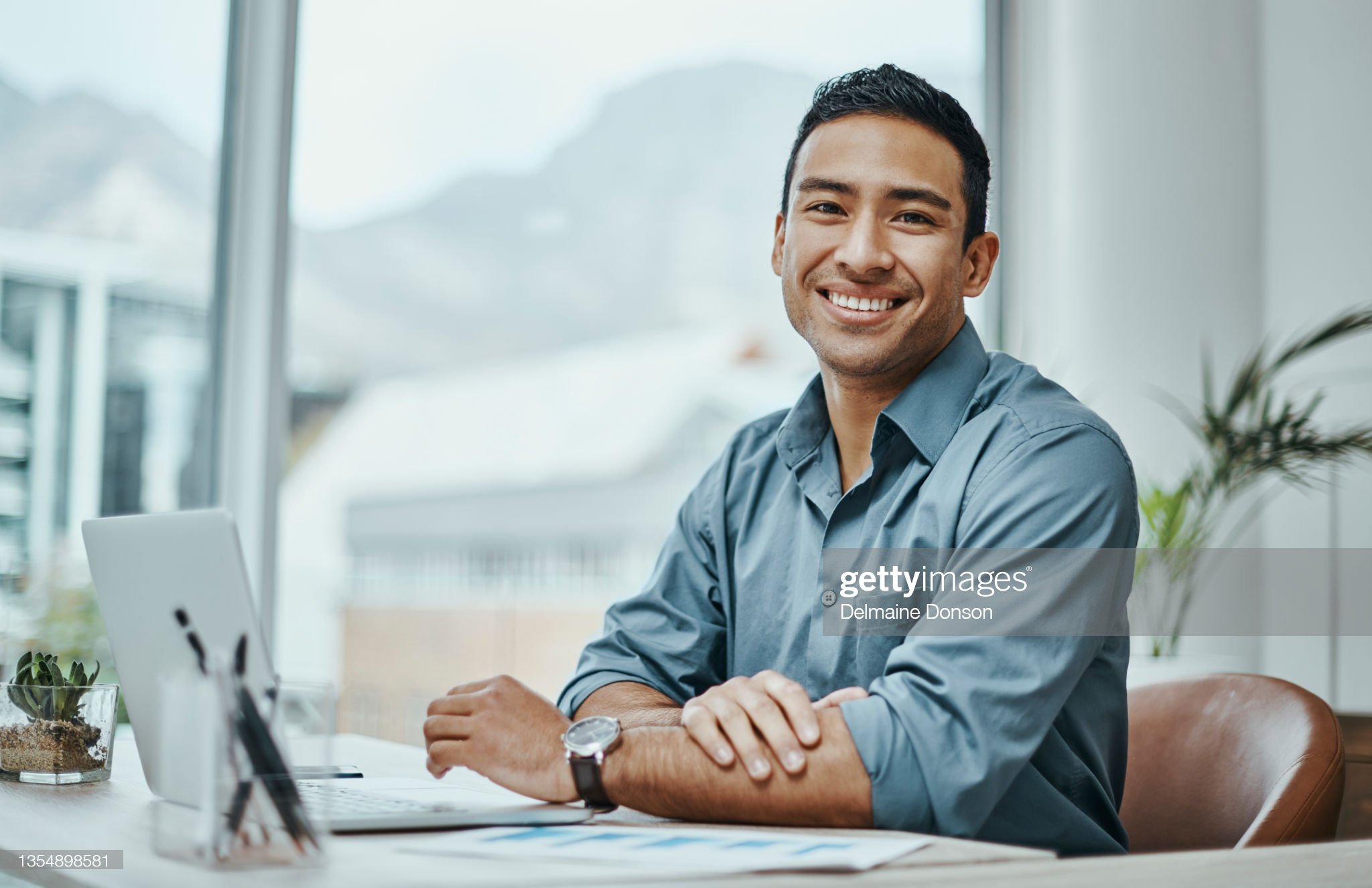 Close up headshot portrait of smiling young Caucasian businessman in glasses posing in office. Profile picture of happy millennial male employee or worker in eyewear at workplace. Employment concept.