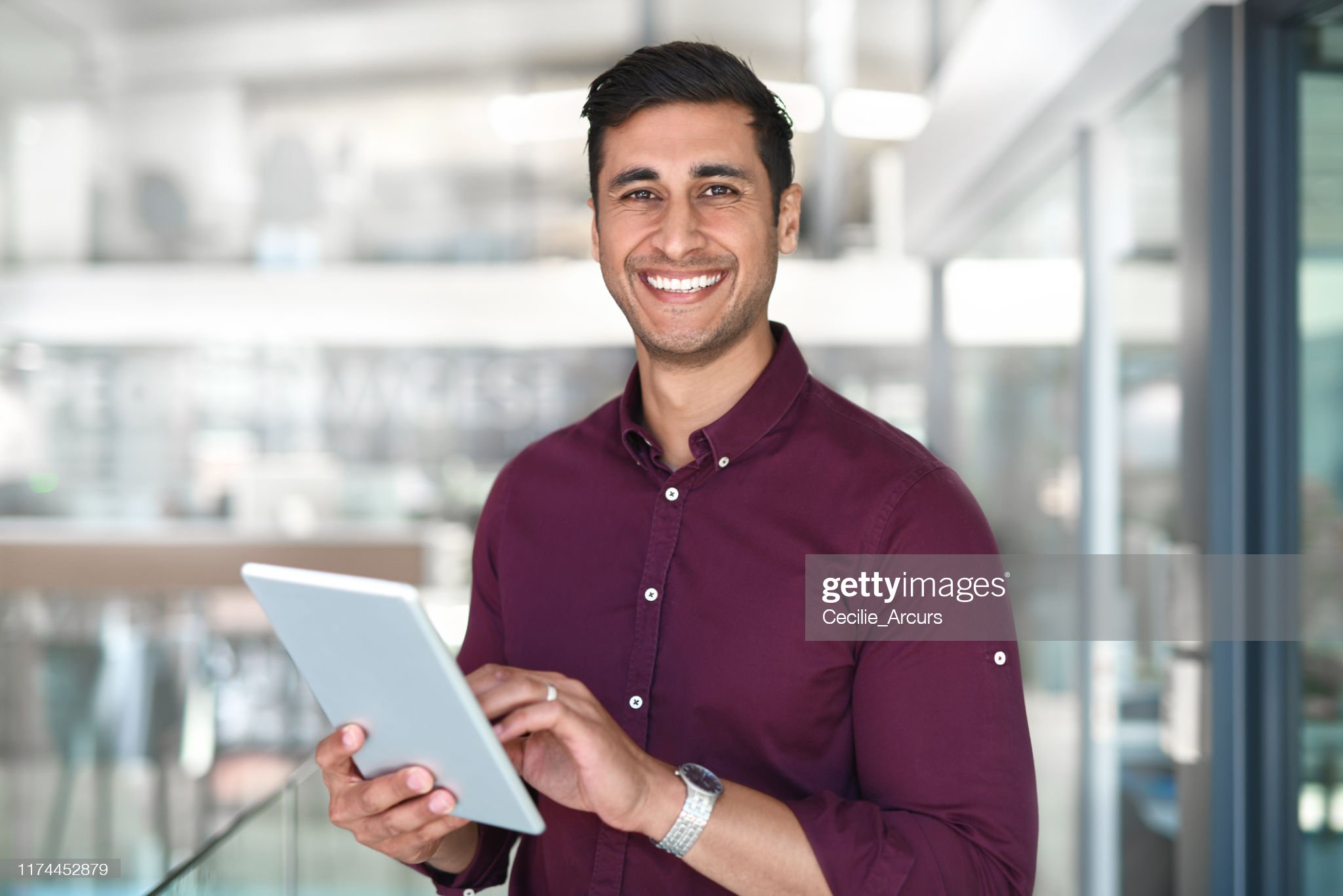 Pleasant smiling young indian woman freelancer looking at camera consult client from computer phone screen via video call. Headshot portrait of mixed race lady taking part in web conference from home